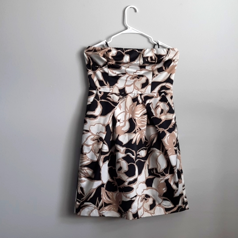 Floral black, white, and gold strapless Limited dress with pockets.